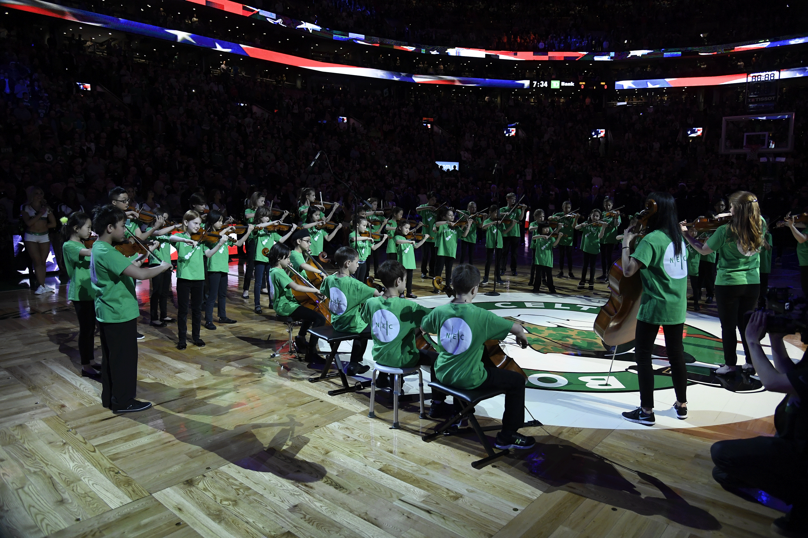 Children in NEC's Suzuki Prep program play at the Celtics stadium