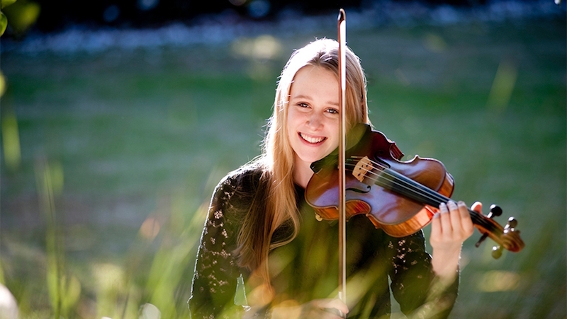 Grace Clifford smiles and plays the violin
