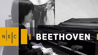 The word "Beethoven" over a black and white image of a pianist closing their eyes and seated at the piano