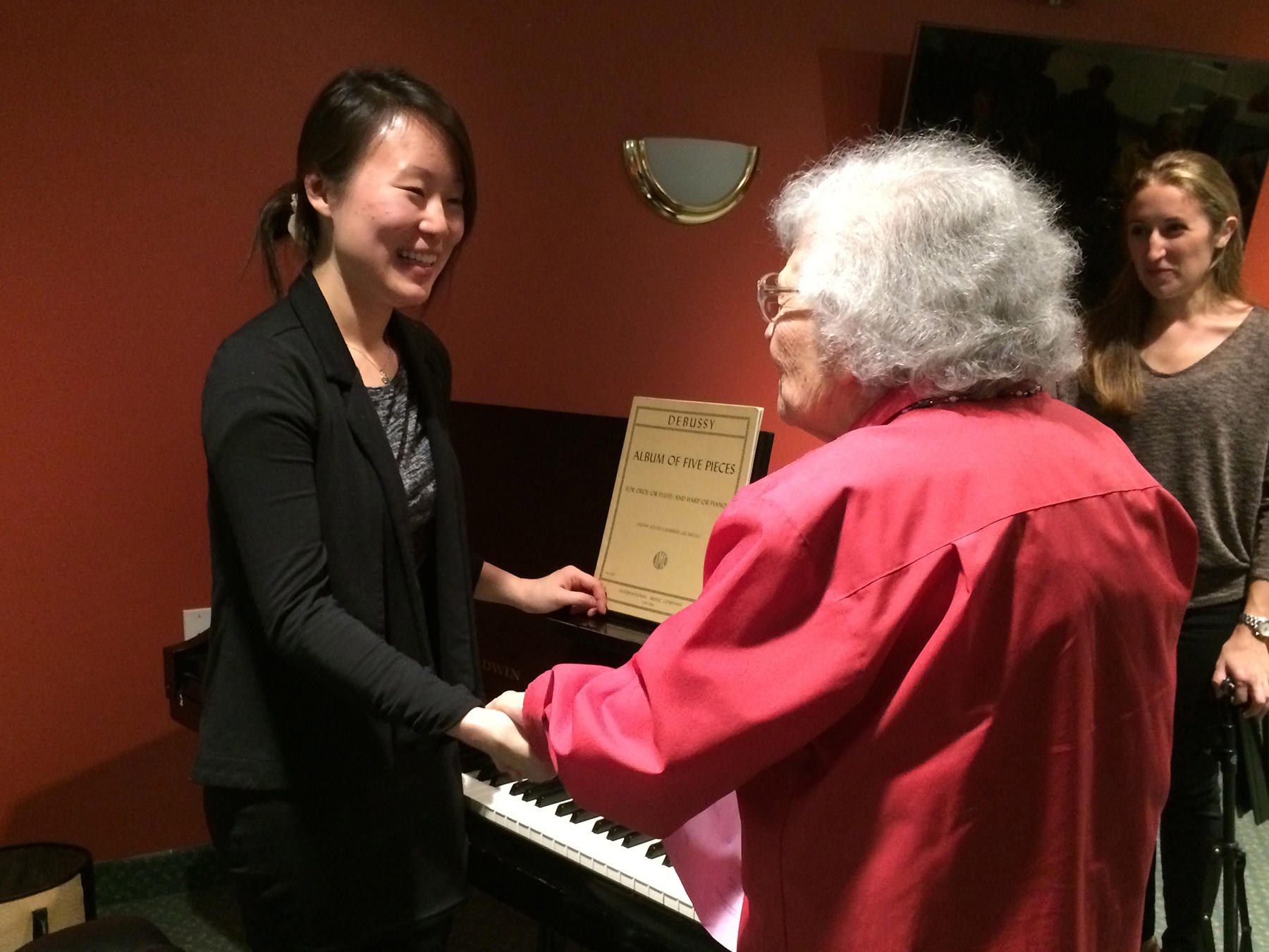 Pianist shakes hands with a senior citizen