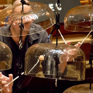 A percussionist performs on glass bells