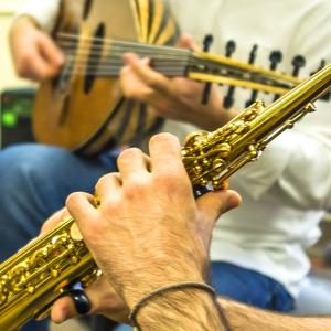A closeup of a musician's hands playing saxophone.