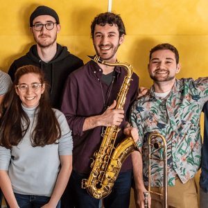6 students in a jazz ensemble pose and smile