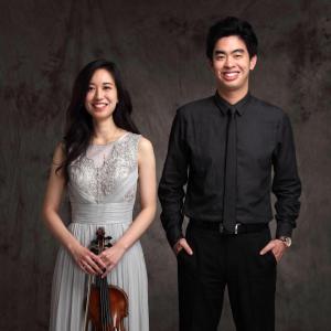 Rose Hsien and Andrew Hsu stand side by side in formal attire. Both smile towards the camera.